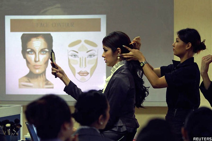 Transsexual flight attendant Dissanai Chitpraphachin, 24, has her hair done during a hair-dressing training session at PC Air office in Bangkok February 9, 2011. A newly formed Thai airline PC Air wants to make a different from their competitors by hiring the transsexual flight attendants. Be pretty and be feminine are the qualification the ladyboys should have to join a new charter airline that will begin the operation in early April. The airline has recruited four ladyboys, 19 female and seven male but said they will need to employ more of transsexual on their flights in the future.  REUTERS/CHaiwat Subprasom (THAILAND - Tags: SOCIETY ODDLY TRANSPORT)