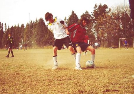 Two kids at the Cordoba Cup fighting for the ball