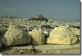 View of ancient temple remains. At the background, Lycabetus hill is sighted View of ancient temple remains. At the background, Lycabetus hill is sighted