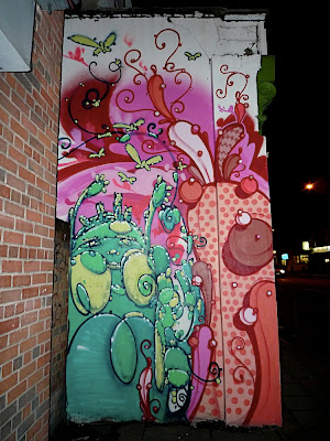 bright pink and green mural with butterflies