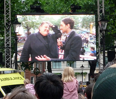 two men on a big screen