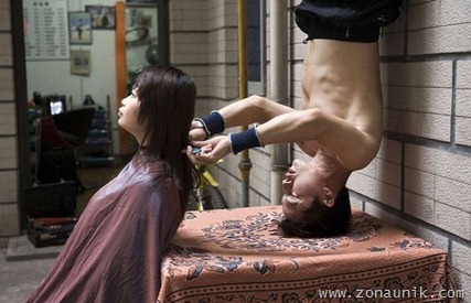 Wang Xiaoyu performs headstand haircut