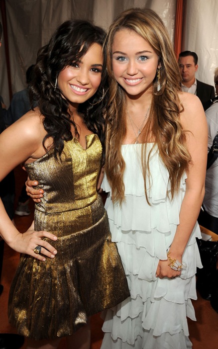 Actress Demi Lovato (L) and singer/actress Miley Cyrus arrive at