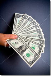 ist2_1332157-hand-full-dollars