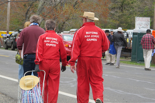 People often wear signs or their own clothes that advertise what they are hunting for. This couple wore matching exercise suits to hit the fields and get the world out about mah jongg.