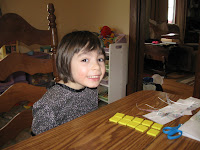 Madeline moving around tiles to practice even and odd numbers