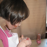 Madeline carefully works on a beautiful cookie