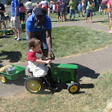 Erik drives a tractor for Little Hands on the Farm