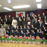 All the kids, parents, and teachers. Kai's in the middle of the front row, and Maria, Eidan, and I are in the back, on the right.