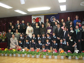All the kids, parents, and teachers. Kai's in the middle of the front row, and Maria, Eidan, and I are in the back, on the right.
