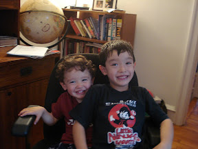 Eidan and Kai sharing my desk chair