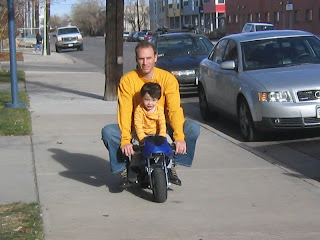 Kai and James riding a mini bike in Denver Kai and James riding a mini bike in Denver