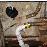 After we replaced the cracked pipe, we made a temporary PVC connection for the tub drain so we could at least use the shower. You can see there's no framing at all to support the toilet