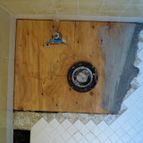 The new subfloor, with the waste pipe roughed in (and some mortar to patch the gap on the side)