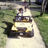 Kai and Eidan riding on the neighbor's battery powered mini Jeep Kai and Eidan riding on the neighbor's battery powered mini Jeep