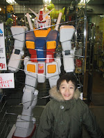 Kai with a giant Gundam, at a toy store in Ebisu, Tokyo