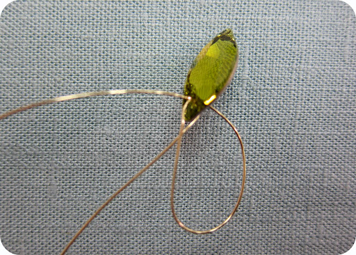 Creating a branch step 1: start out with 1.5 yards of 26 gauge wire (this will make a big and small branch). String 1 leaf sew-on bead, leaving 9