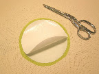 Place second freezer paper circle shiny side UP on top of fused circle. Use a couple small pieces of double-sided tape to temporarily tack the two together.