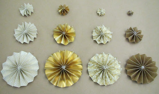 I prepped all of my medallions in various colors/patterns per Cindy's specs (see the link above for instructions and a template) and I hot glued all of the medallions together using a circular punched piece of paper between each layer (as instructed).
