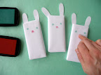 Using another finger with a red stamp pad, print noses on your bunnies.