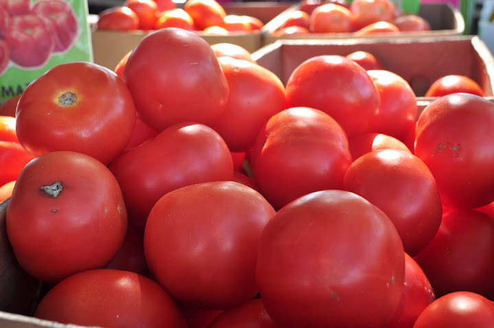 7/11/2010-The sun shines on a box of tomatoes sold at one of the opening stalls.