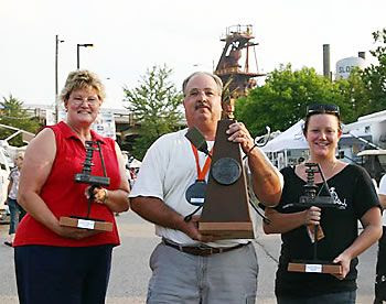 Fourth place pork, third place brisket and Reserved Grand Champion trophies. Voncile and Joe Amore' with lady who help design and sculpture the trophies for Stokin the Fire BBQ Contest - Birmingham, AL 2006.