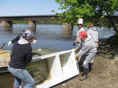Volunteers haul junk off the banks of the Iowa River (Photo Submitted)