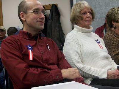 Kalona resident James Graham (left) is among those who donned pins reading Free County at this Week's board of supervisors meeting