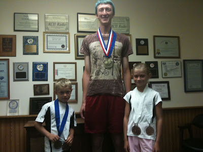 Iowa Games Medalist Cole Anderson (Washington) , Joseph Altmaier (Riverside), and Hannah Anderson (Washington).