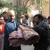 Arshad ji distributing blanket and biscuit