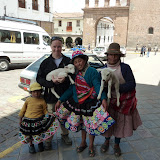 Dee poses with locals and lambs