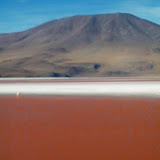 Panoramic red laguna backed by another volcano