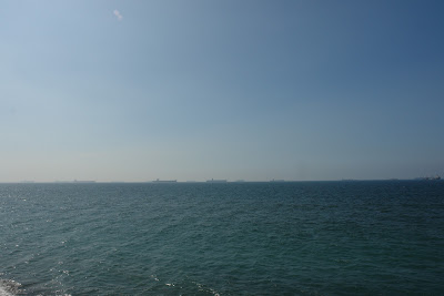 Cargo ships lining up to enter Kaohsiung Port, as seen from Cijin Island.