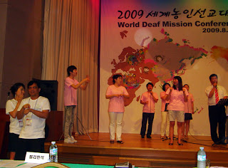 Day 3 (9:00 am) - Sir Jojo interprets the Worship-Lecture Service at Dreamtel Conference Hall. Ms. Hanna Jong, Korean interpreter is beside him.