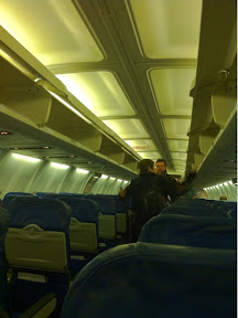a couple of people standing in an airplane
