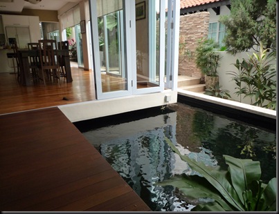 koi pond located close to dining room of house