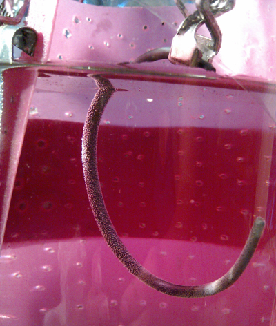 titanium bracelet being electrolytically anodized titanium bracelet being electrolytically anodized