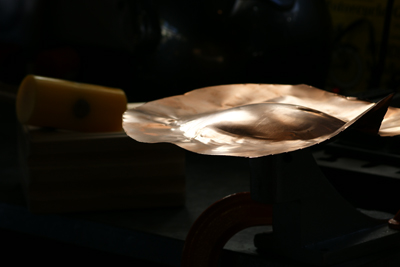 Sherry Cordova forming copper over large mushroom stake Forming copper over large mushroom stake