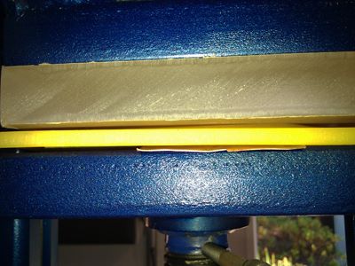 16 ga brass and 2 pieces of tempered masonite cut into shield silhouette die by Pat Accorinti Yellow urethane sheet 24 ga copper sheet pressed in 20 ton hydraulic press