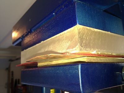 16 ga brass and 2 pieces of tempered masonite cut into shield silhouette die by Pat Accorinti thinnest red urethane sheet 24 ga copper sheet pressed in 20 ton hydraulic press