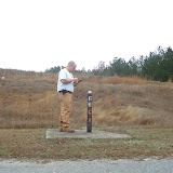 A typical monitoring well. AEM's Field Manager, Eric Benton, enters data in a handheld computer. The electronic data is e-mailed to AEM's project managers to provide quicker QA/QC and report preparation.