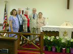 Roxanne Myers, Jim Oakley, Anita Luff, Bill Luff, and Sally Duhon, who all helped decorate the sanctuary for Easter, pose near the altar on Easter Sunday, 2008.