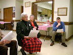 Anita Luff, Sally Duhon, and James Anderson hear the Vicar's Report during the Annual Meeting.
