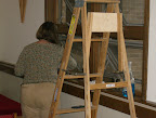 Mitzi George preparing the windows for installation of the stained glass.