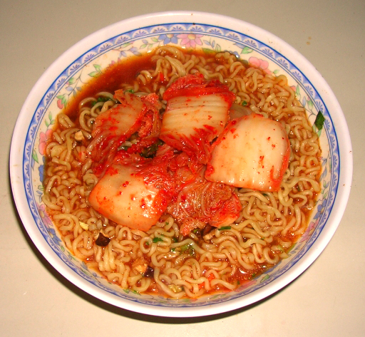 A bowl of prepared Shin ramyun instant noodles, topped with kimchi.|By Pravit726 from Wikipedia
