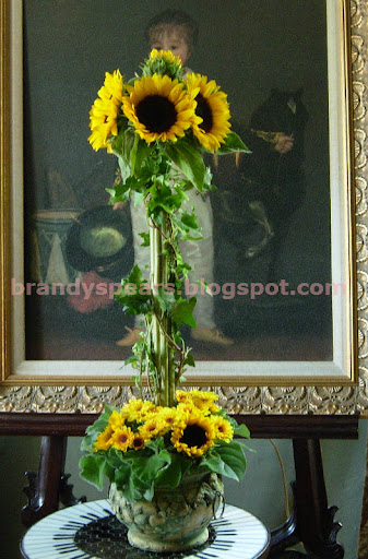  with ivy and yellow with brown centered mums as an accent flower