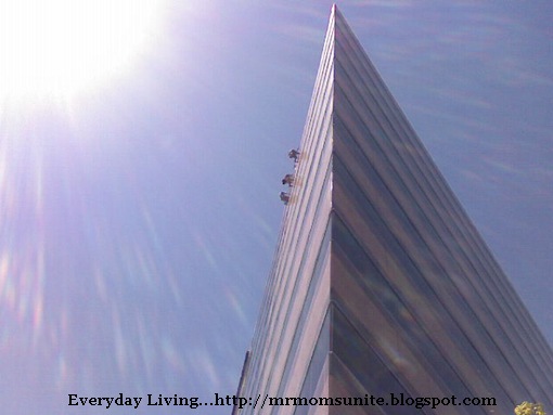 photo of window washers on the roof of a high-rise