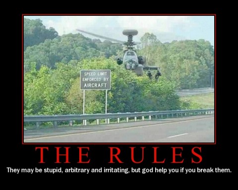 photo of an apache helicopter hovering behind a speed enforcement sign