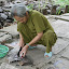 Happily chopping a fish into its component quarks, this lady barely noticed the herd of tourists troop by.