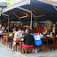 Each table is a different restaurant with a different chef, cooking out of a tiny kitchen at the head of the table. Great good, bustling atmosphere and beer at only 10p. Fantastic.